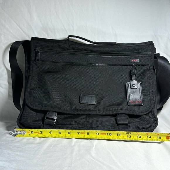 Tumi black ballistic nylon messenger bag. Adjustable strap. Multiple pockets. - Picture 1 of 10